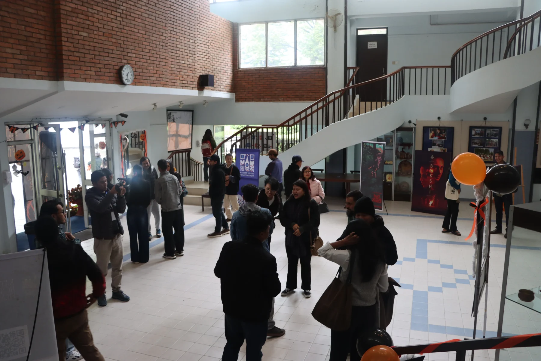Audience gathered in the venue foyer at Kathmandu Horror Film Fest, with film posters and Halloween decorations