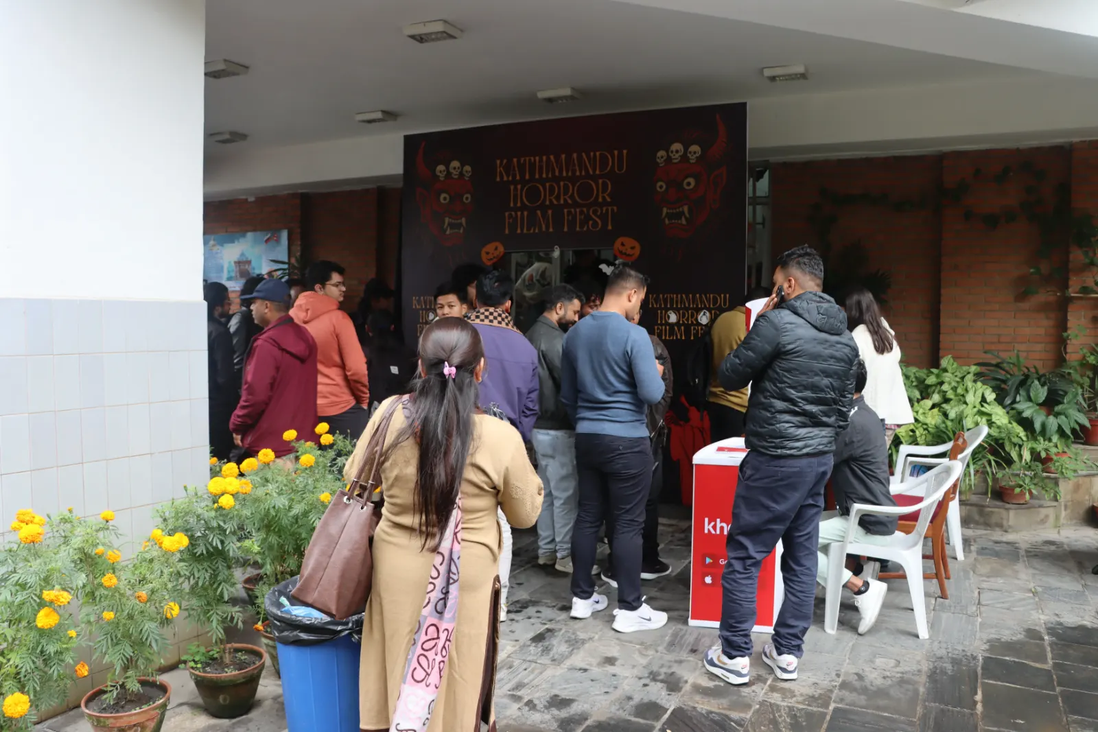 Audience queueing at the festival entrance under the KHFF banner