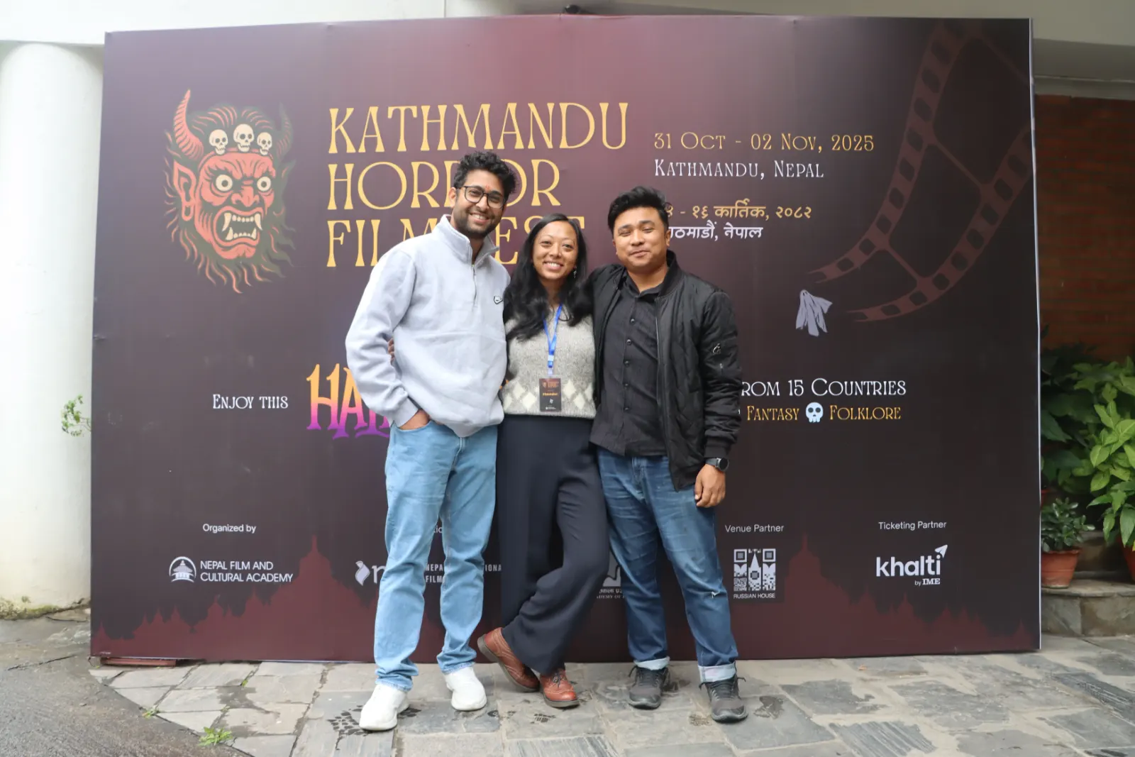 Three guests photographed at the KHFF 2025 backdrop