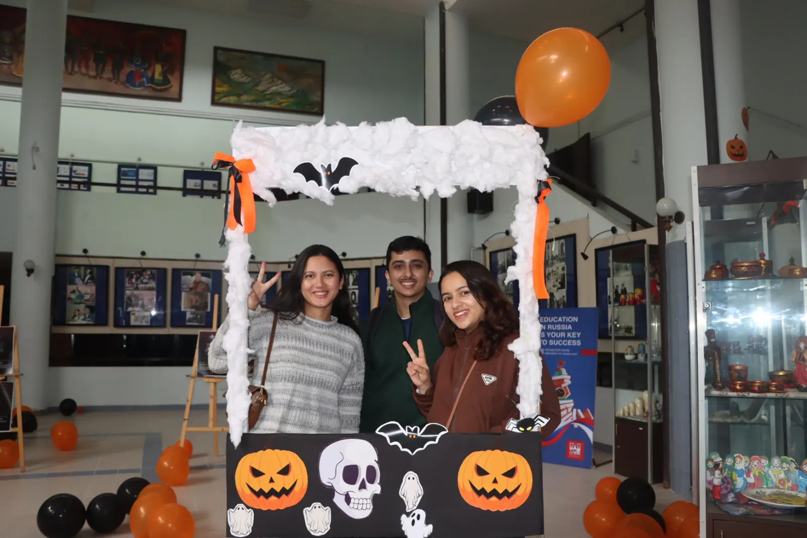 Three attendees at the Halloween photo booth in the venue foyer