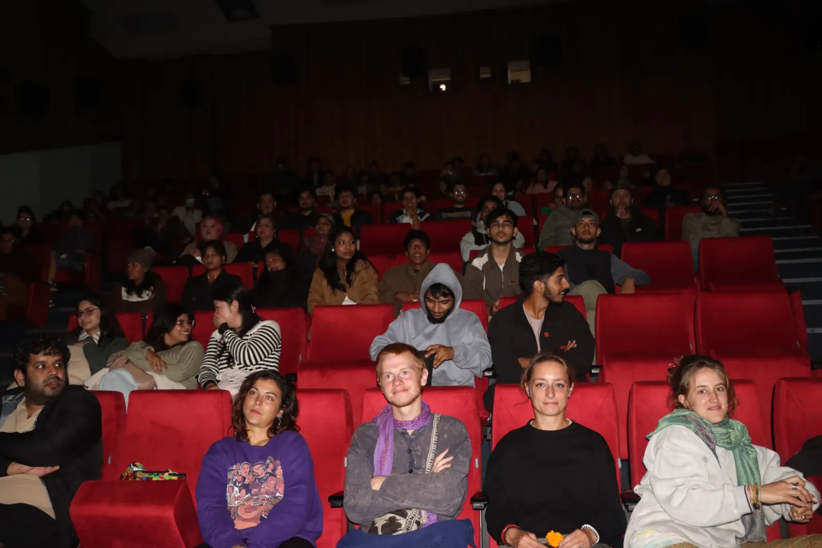 Front rows of the audience watching a film at KHFF 2025